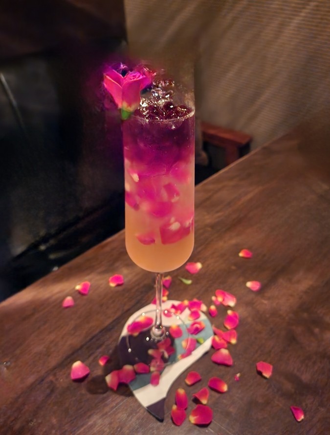 A rose cocktail with petals dancing.